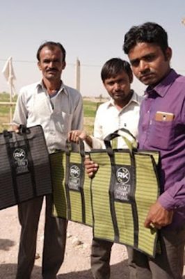 Farmers receiving bags of supplies from RK Group