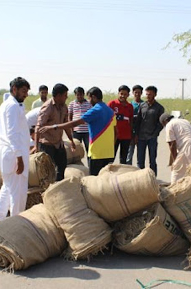 Farmers receiving cumin jute bags from RK Group
